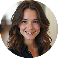 A woman with wavy brown hair and a warm smile, wearing a dark shirt, is pictured in a softly focused indoor setting. The portrait is in a circular frame.