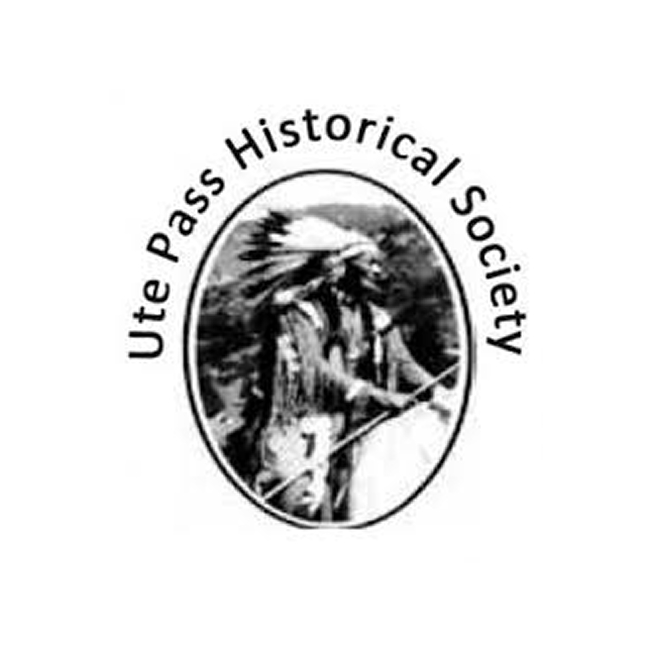 Logo for Ute Pass Historical Society featuring a black and white image of a Native American in traditional attire with a feathered headdress, framed by an oval with the society's name curved around it.